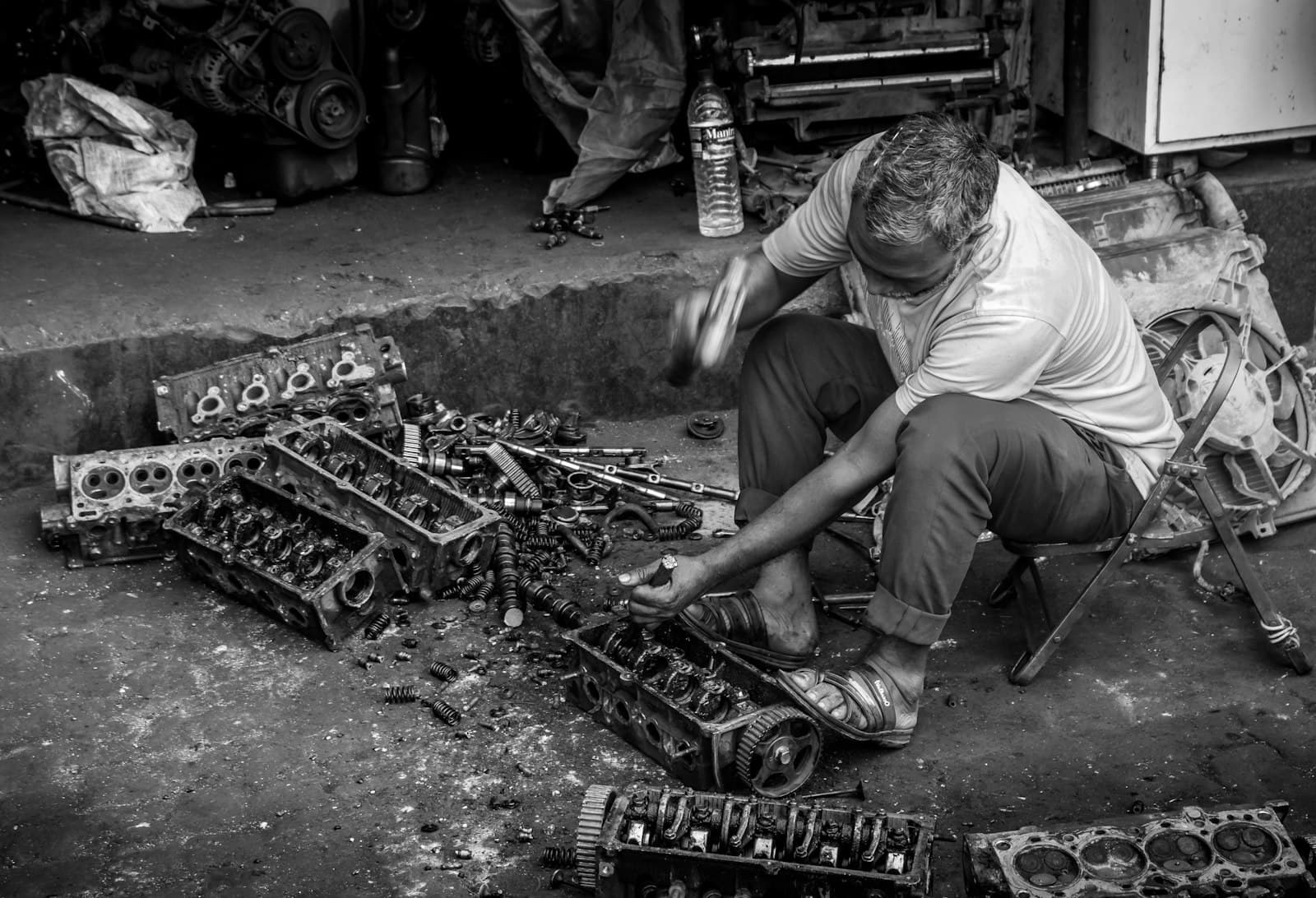 A mechanic installing a used engine in the shop